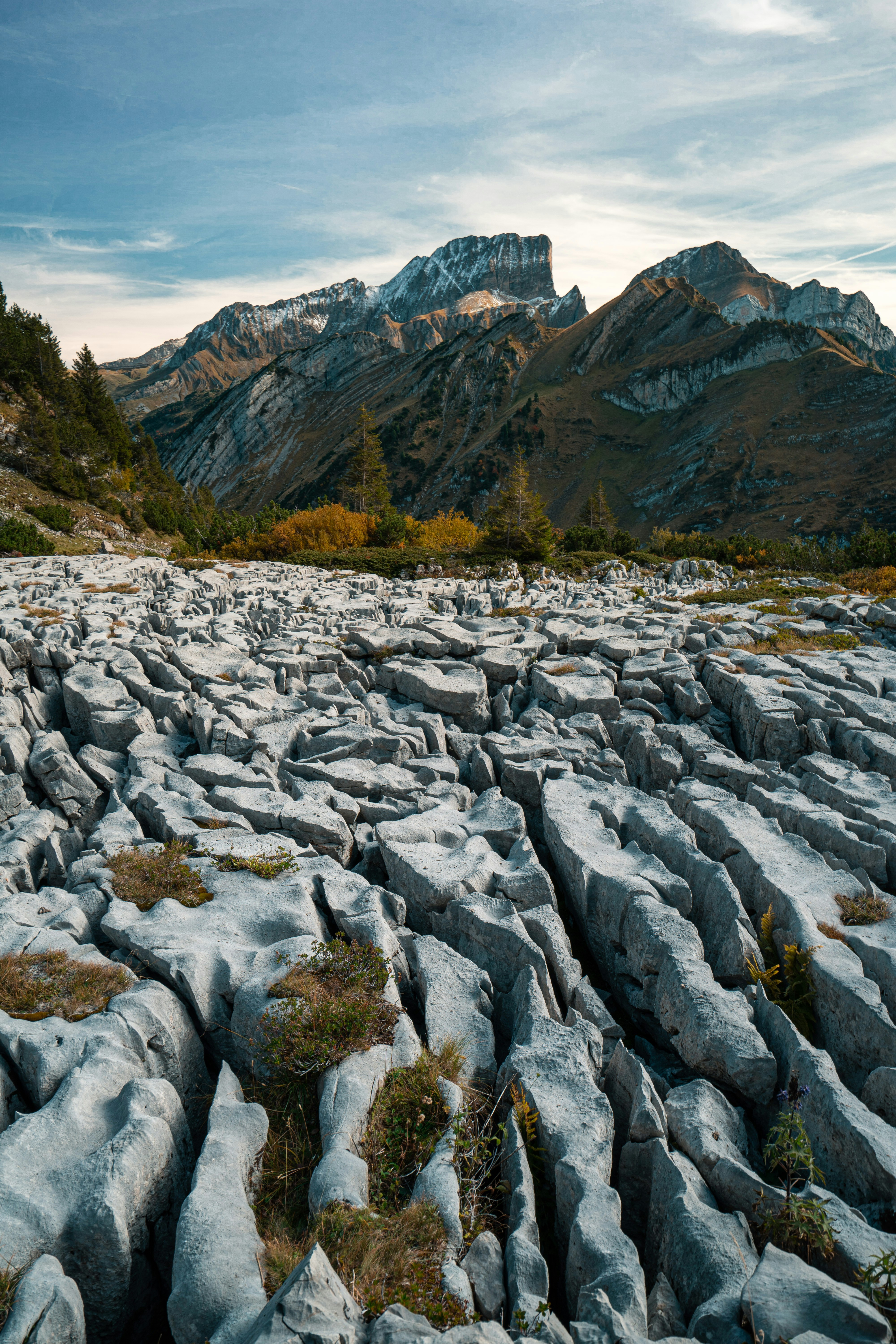 gray rock formations viewing mountain under blue and white sky during daytime